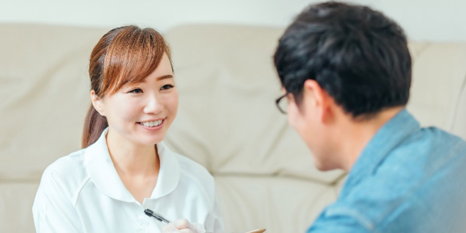 男性の患者さまに説明をする女性スタッフ